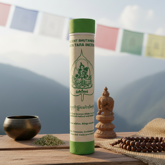 Incense stick tube with green cap and white label on a wooden surface with decorative items.