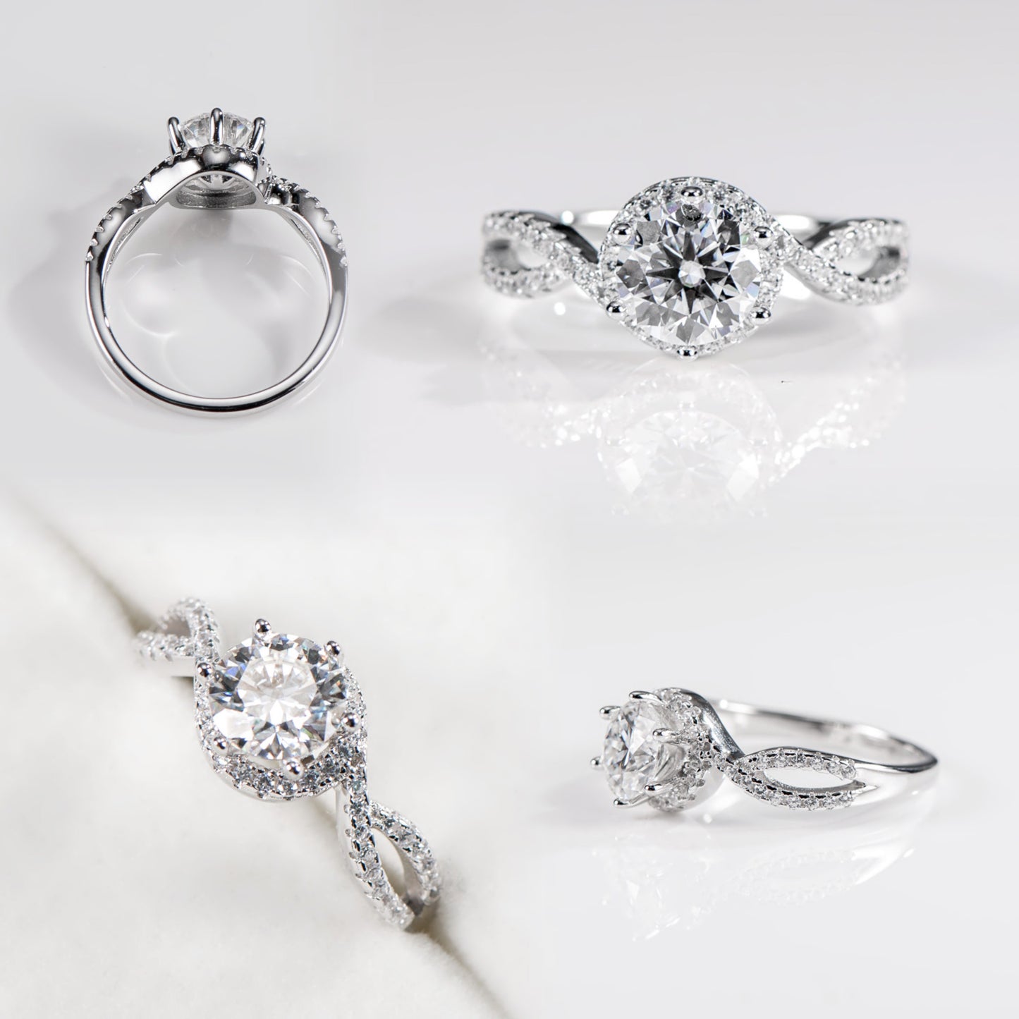 Four silver rings with diamond accents on a light gray background