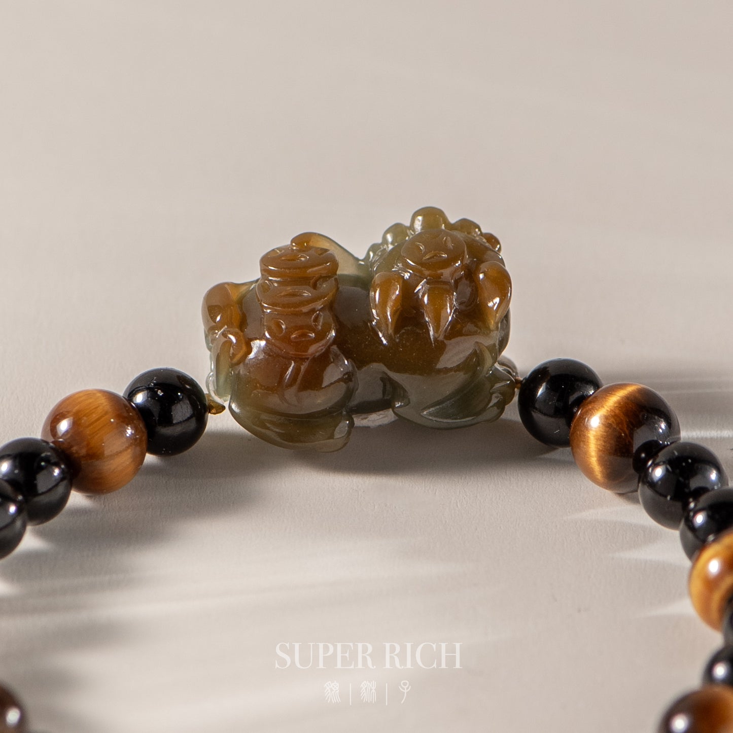 Close-up of a beaded bracelet with decorative elements on a neutral background