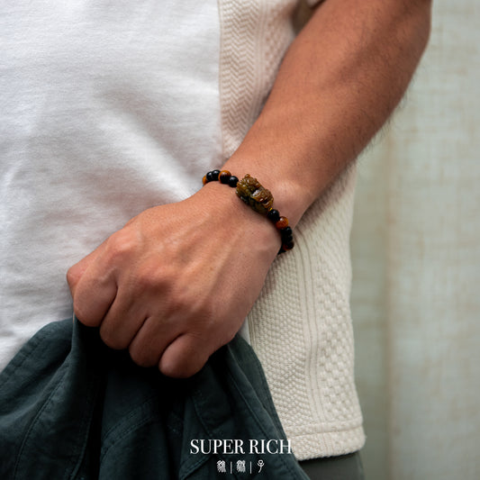Person wearing a beaded bracelet on a neutral background with 'SUPER RICH' branding.