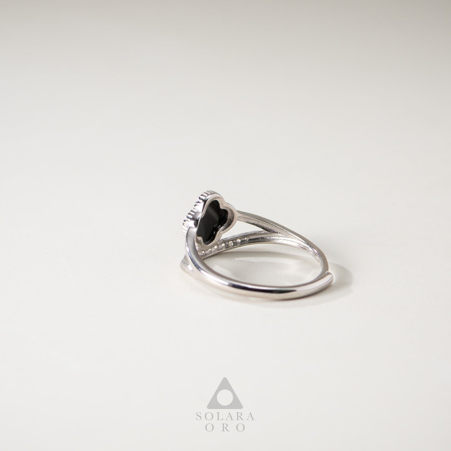 Silver ring with a black gemstone on a white background, featuring the Solara Oro brand.
