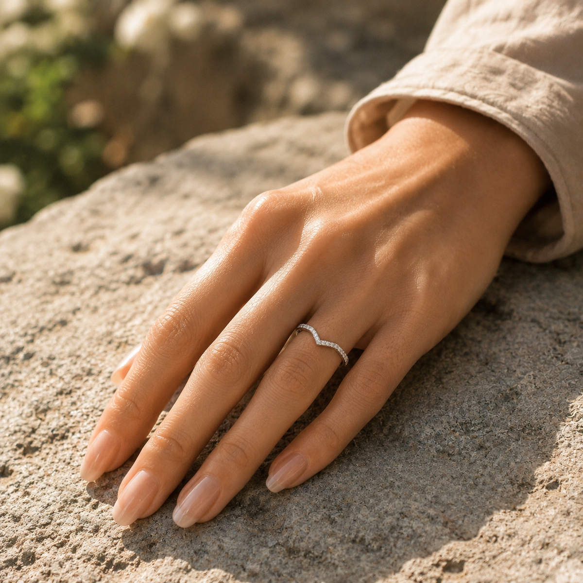 Kairos pavé diamond chevron ring worn on hand outdoors on stone