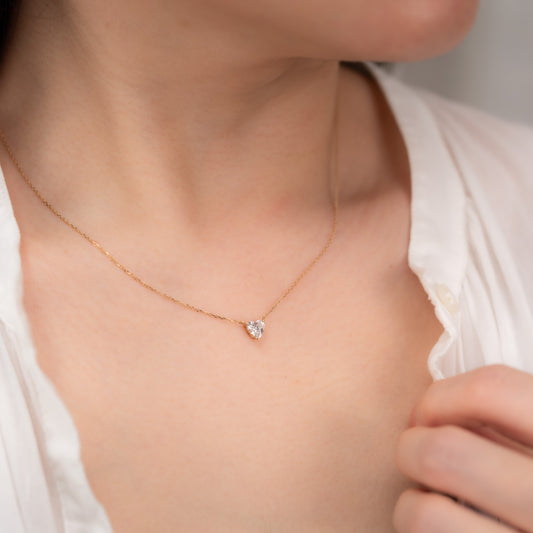 Aurora heart diamond pendant on the neck, showing scale when worn