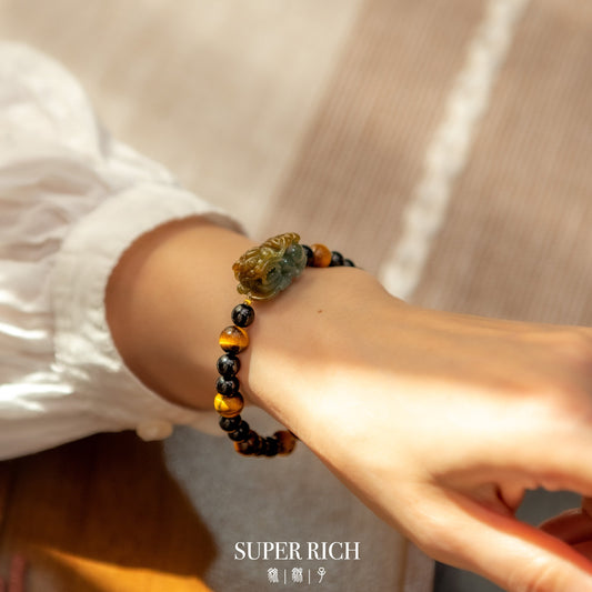 Pixiu bracelets made from jadeite displayed in a calm luxury flat lay for material comparison