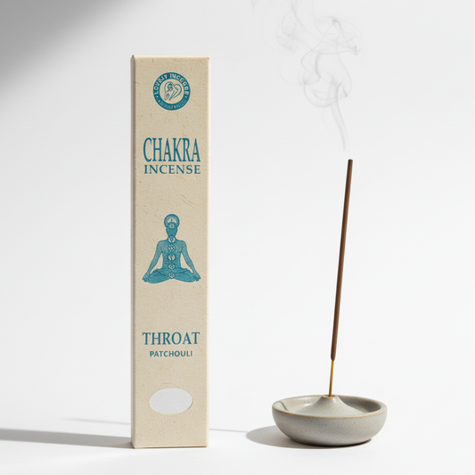 Chakra incense packaging with a lit incense stick and dish on a white background