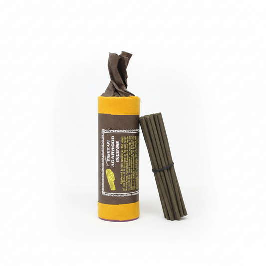 Ancient Tibetan Agarwood incense sticks in decorative tubular packaging on white background