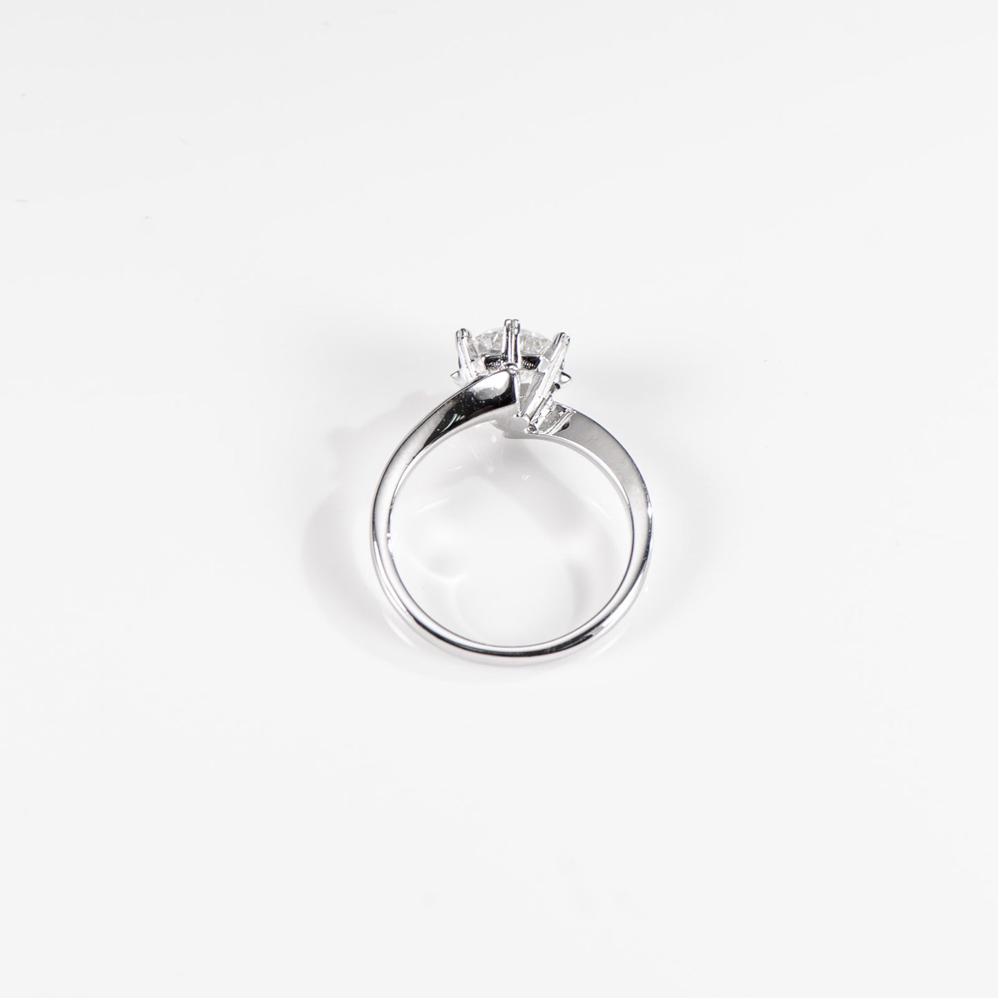 Silver ring with a diamond on a white background