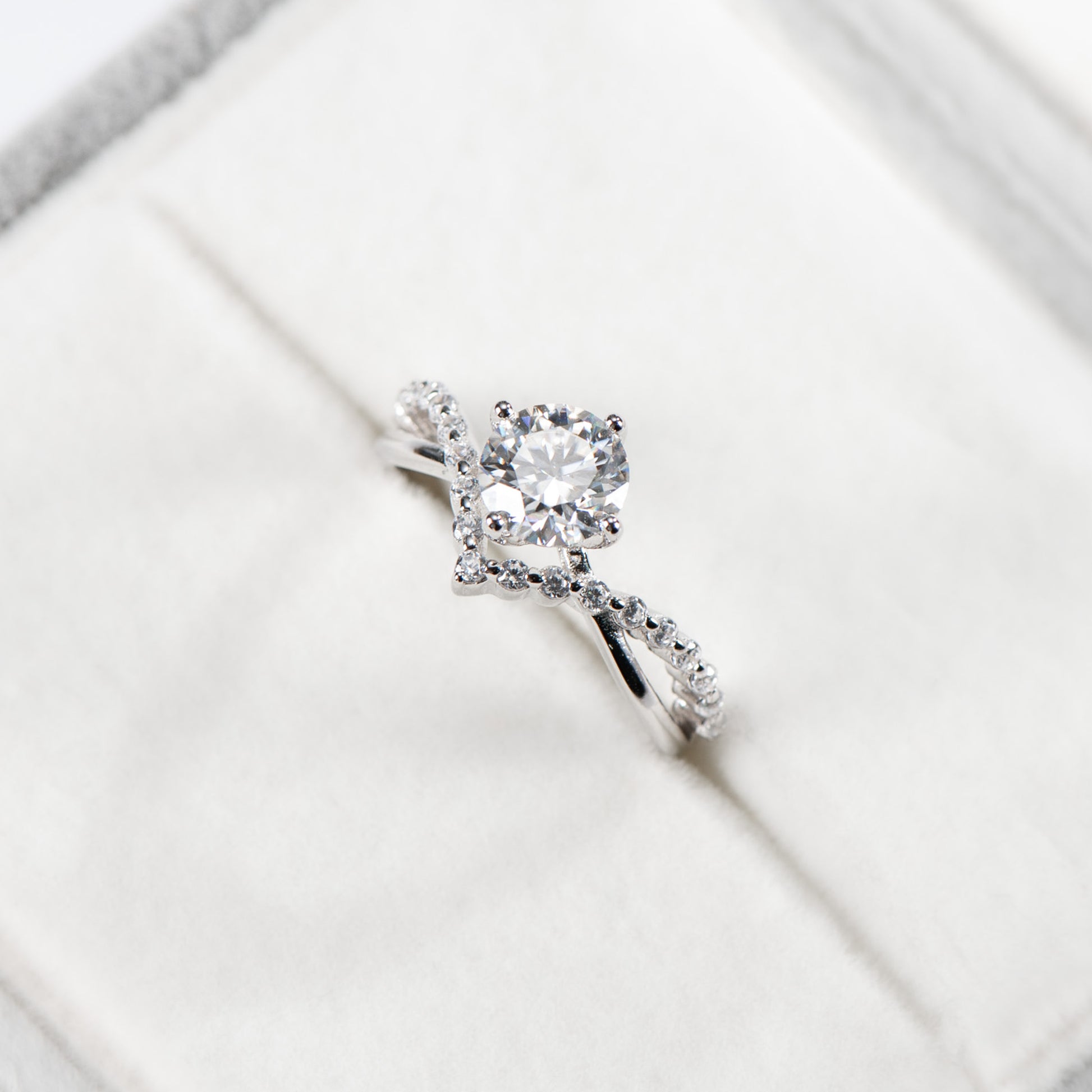 Silver ring with a diamond on a white background