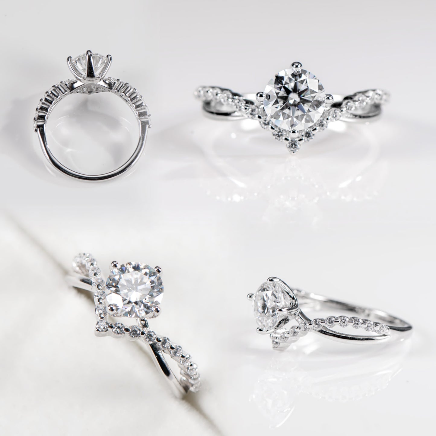 Set of silver rings with diamond-like stones on a light background