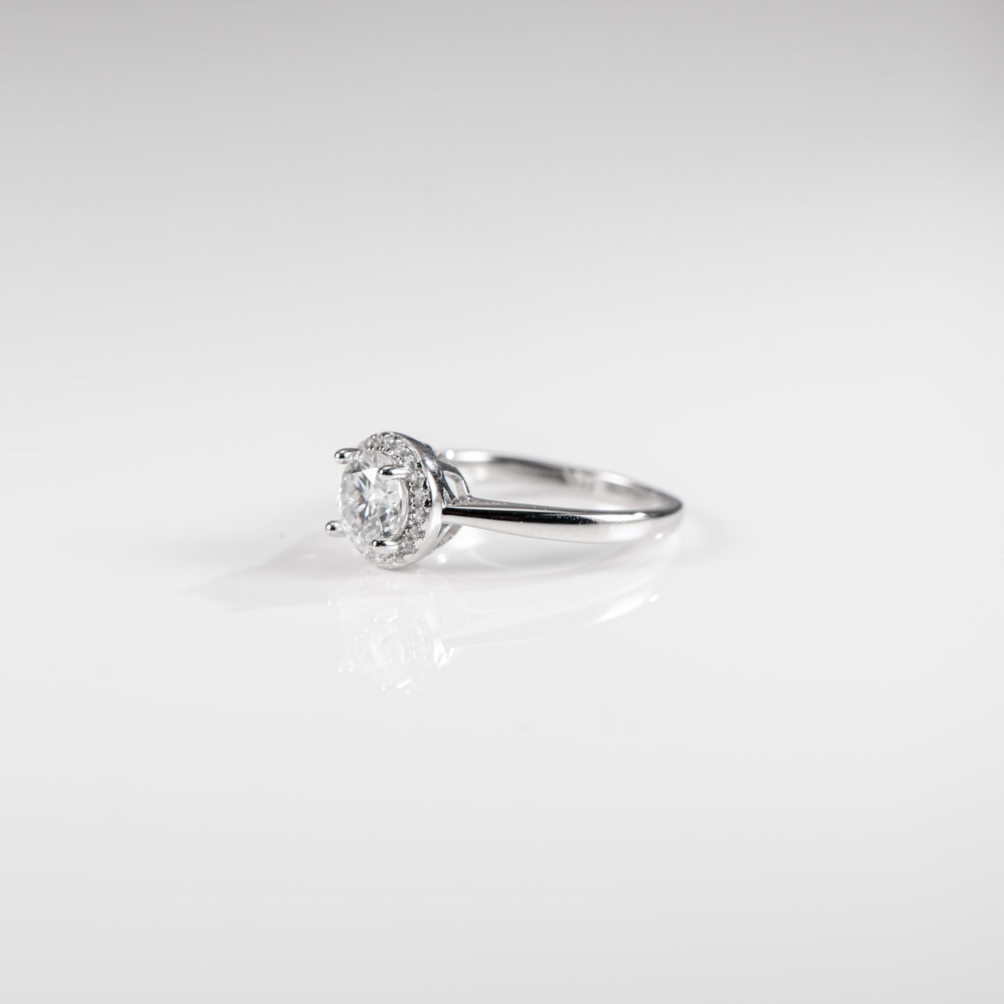 Silver ring with a diamond on a white background