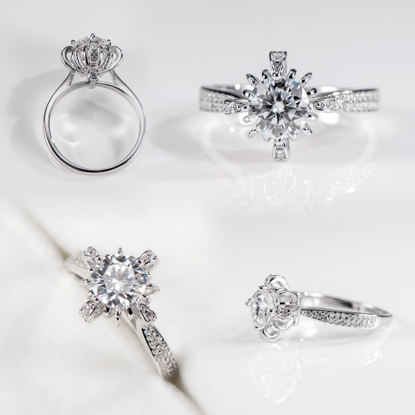 Set of silver rings with diamond-like stones on a light background