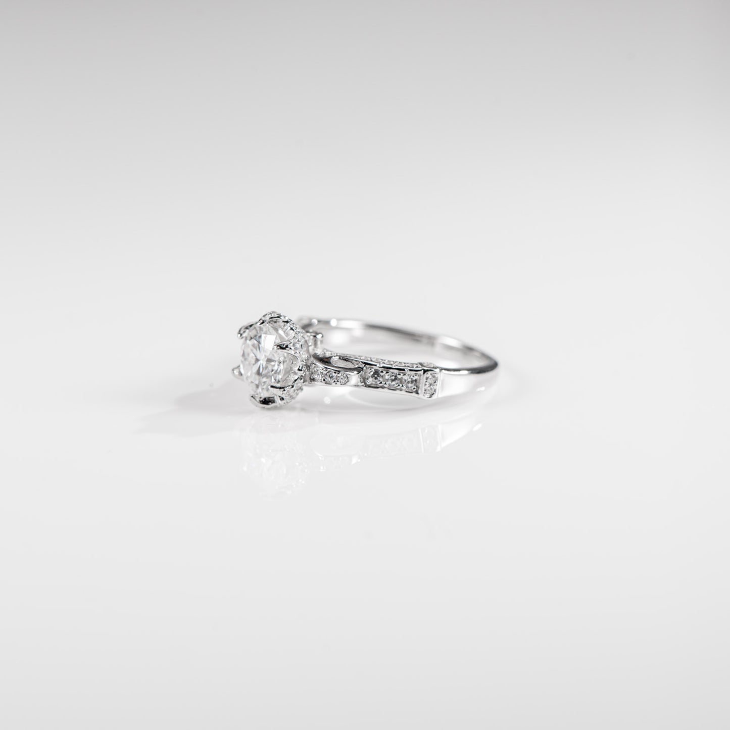 Silver ring with a diamond on a light gray background