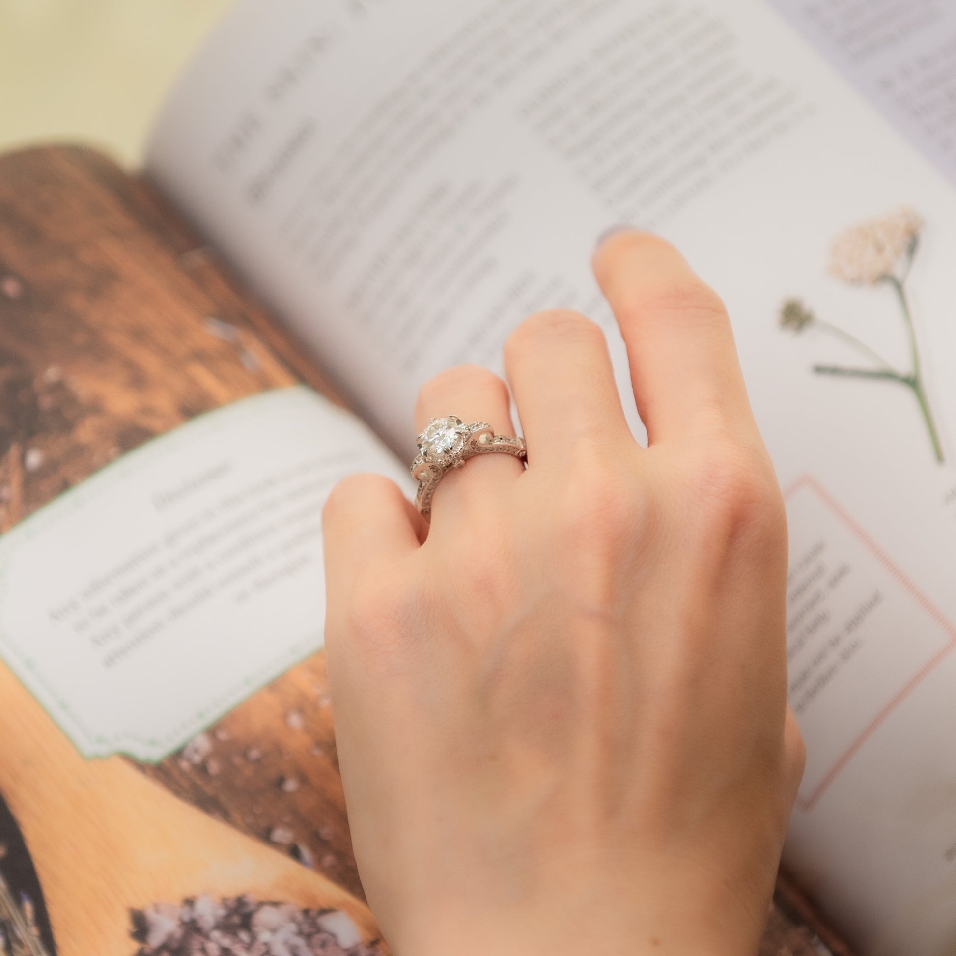 Hand with a ring on an open book