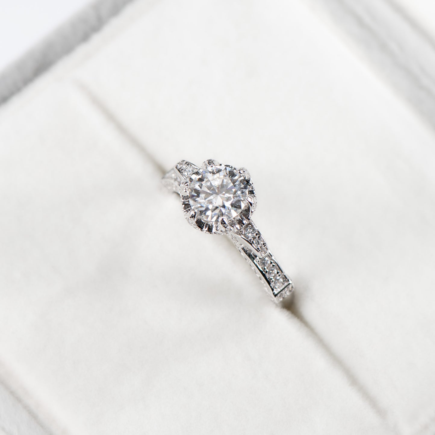 Diamond ring on a white surface