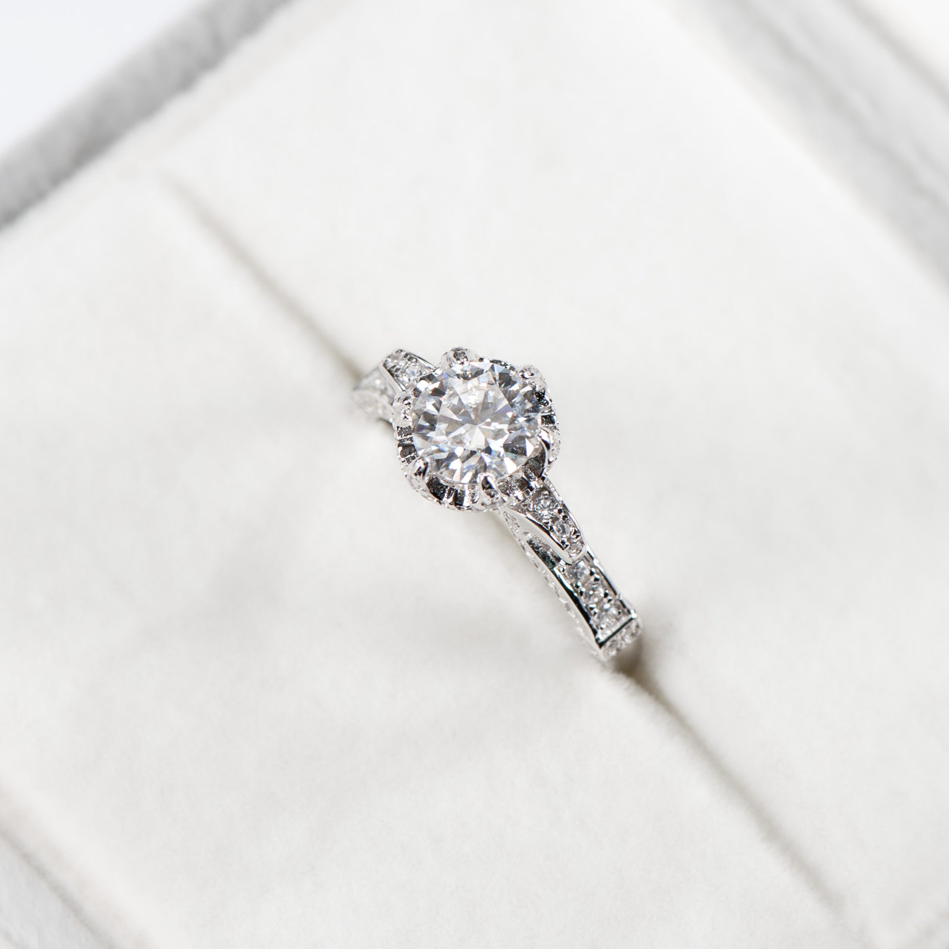 Diamond ring on a white surface