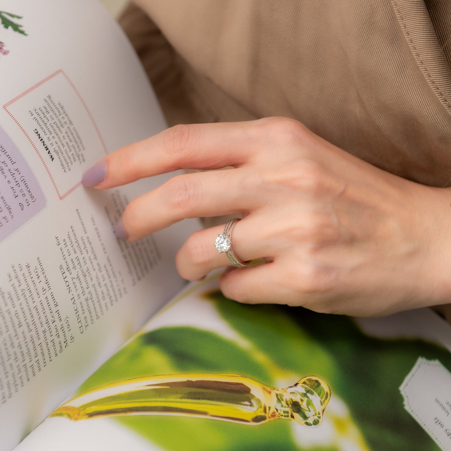 Hand with a ring on an open book, possibly a fairy tale book