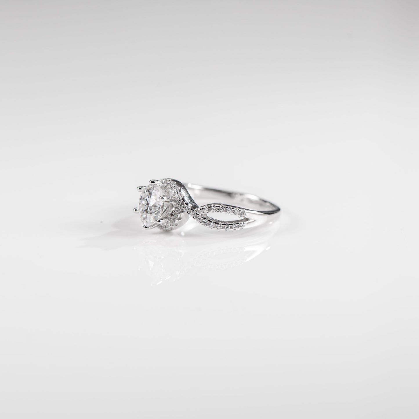 Silver ring with a diamond on a white background