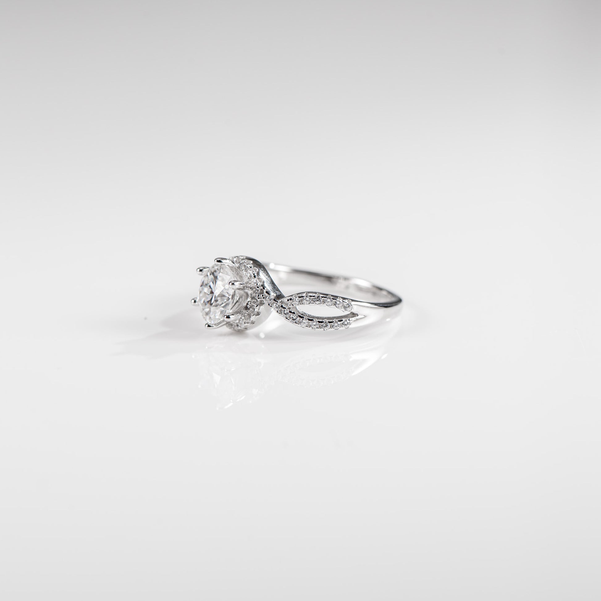 Silver ring with a diamond on a white background