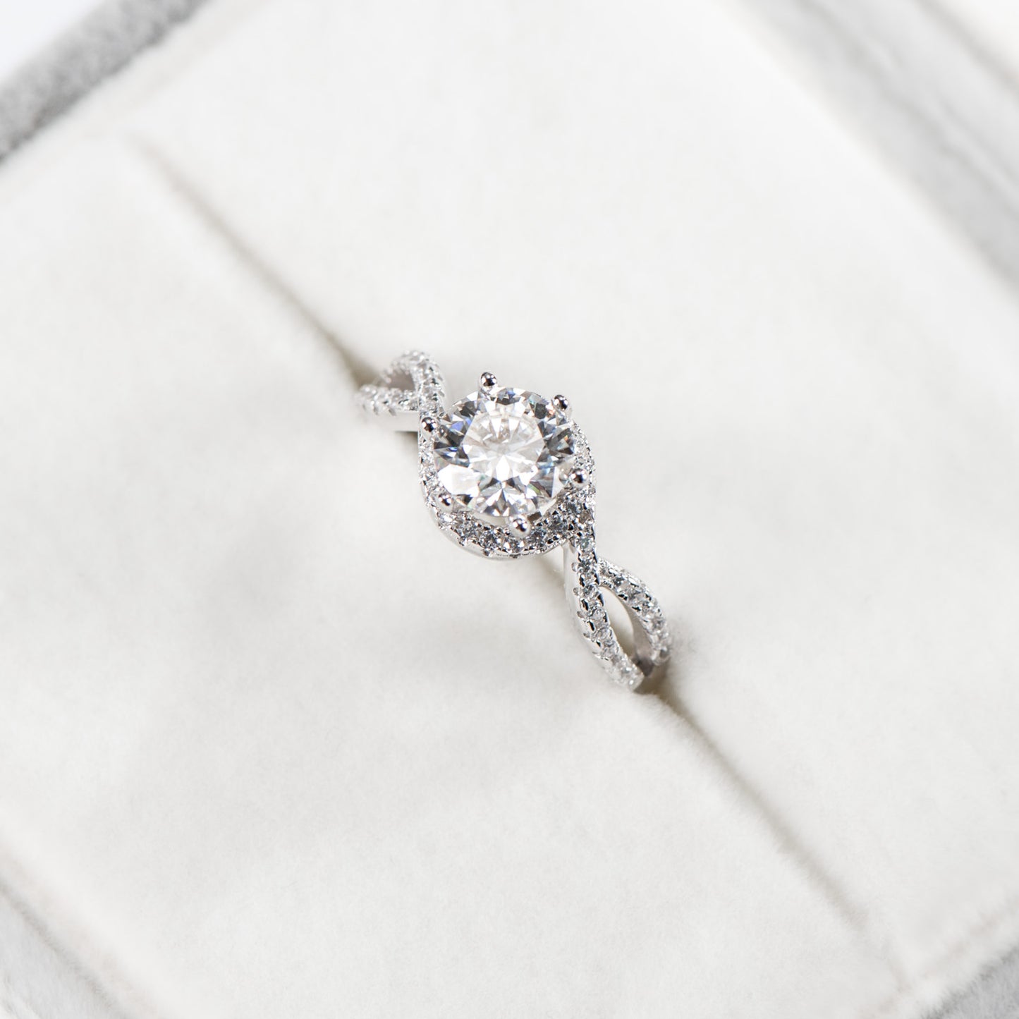 Diamond ring on a white surface