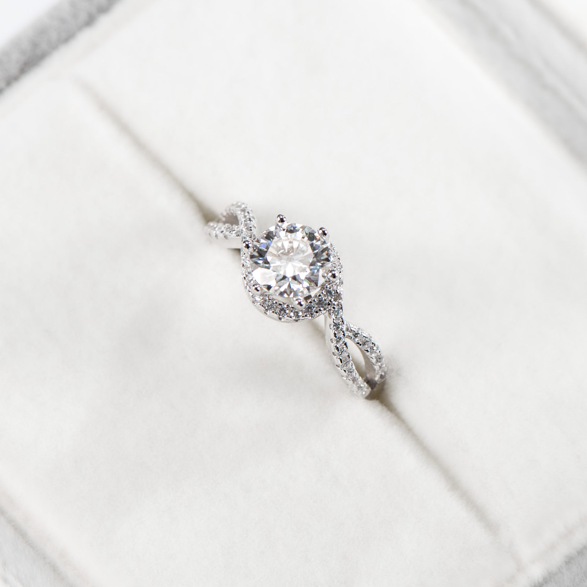 Diamond ring on a white surface