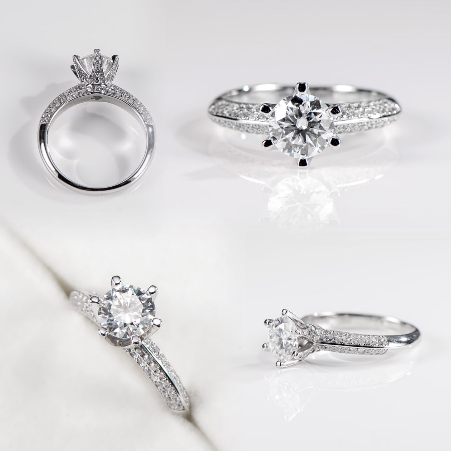 Set of silver rings with diamond accents on a light background