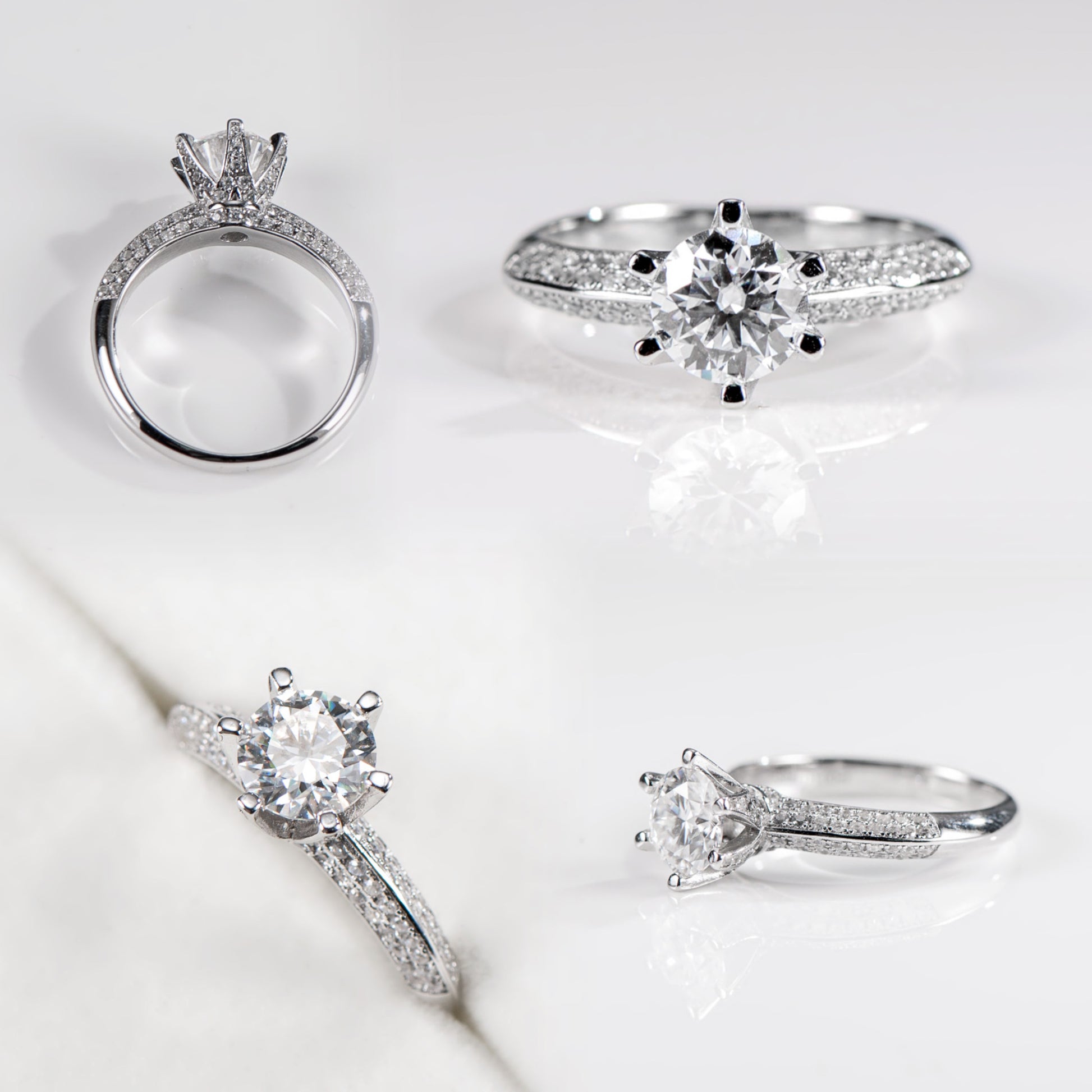 Set of silver rings with diamond accents on a light background