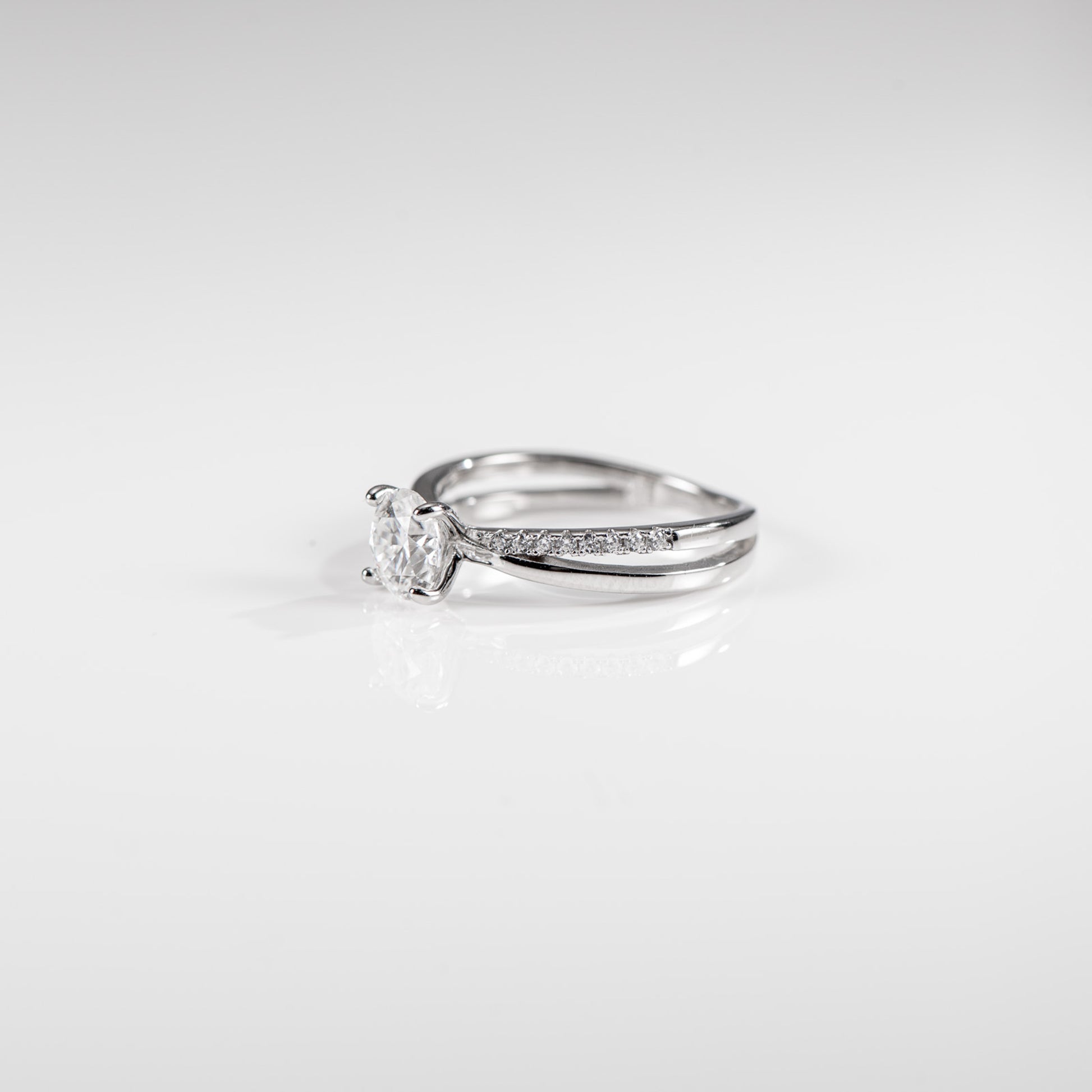 Silver ring with a diamond on a white background