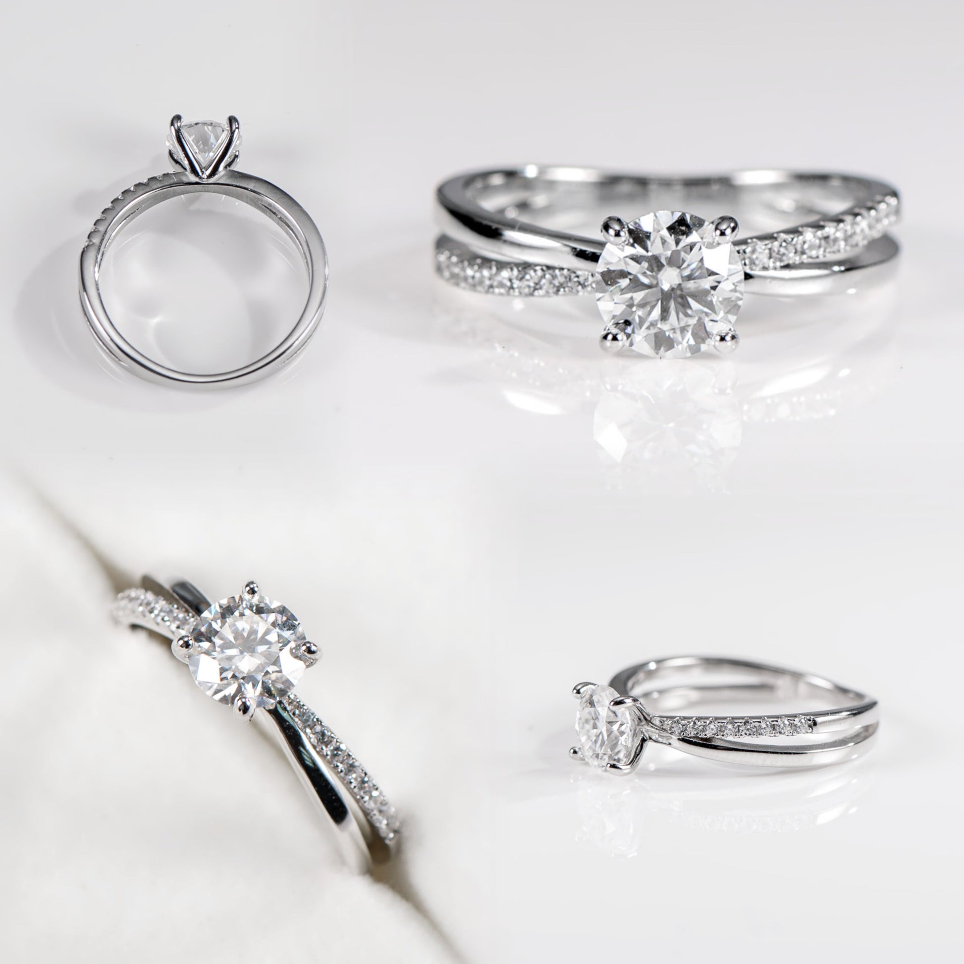 Set of silver rings with diamond accents on a light background