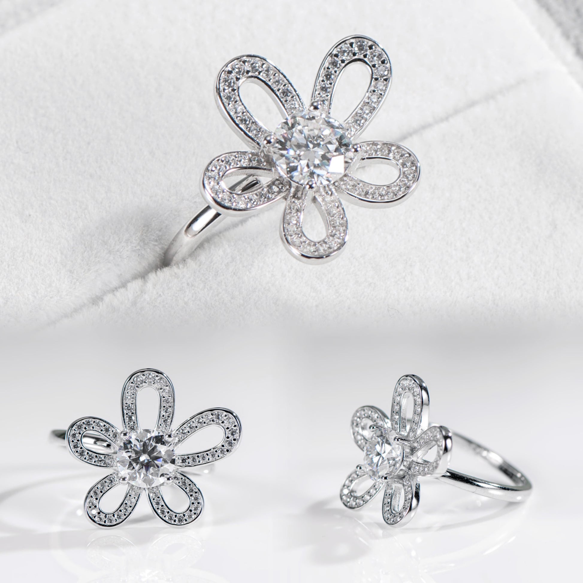 Silver flower-shaped jewelry set on a white background