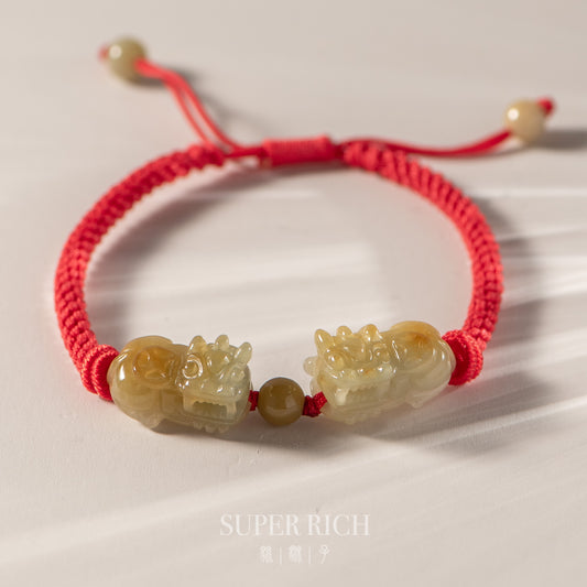 Bracelet with jade-like beads on a red string, featuring the brand 'Super Rich'.