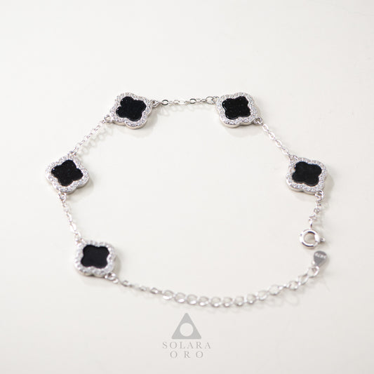 Silver bracelet with black gemstones on a white background, featuring the Solara Oro brand.