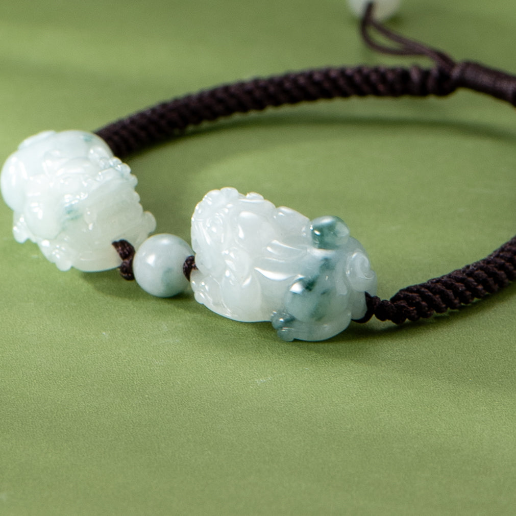 Jadeite jade bracelet with carved elements on a green background