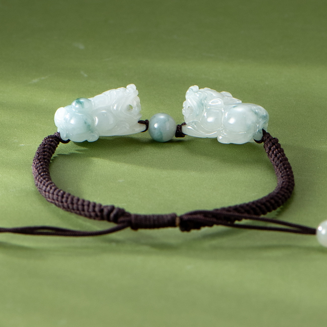 Bracelet with jade carvings on a green background