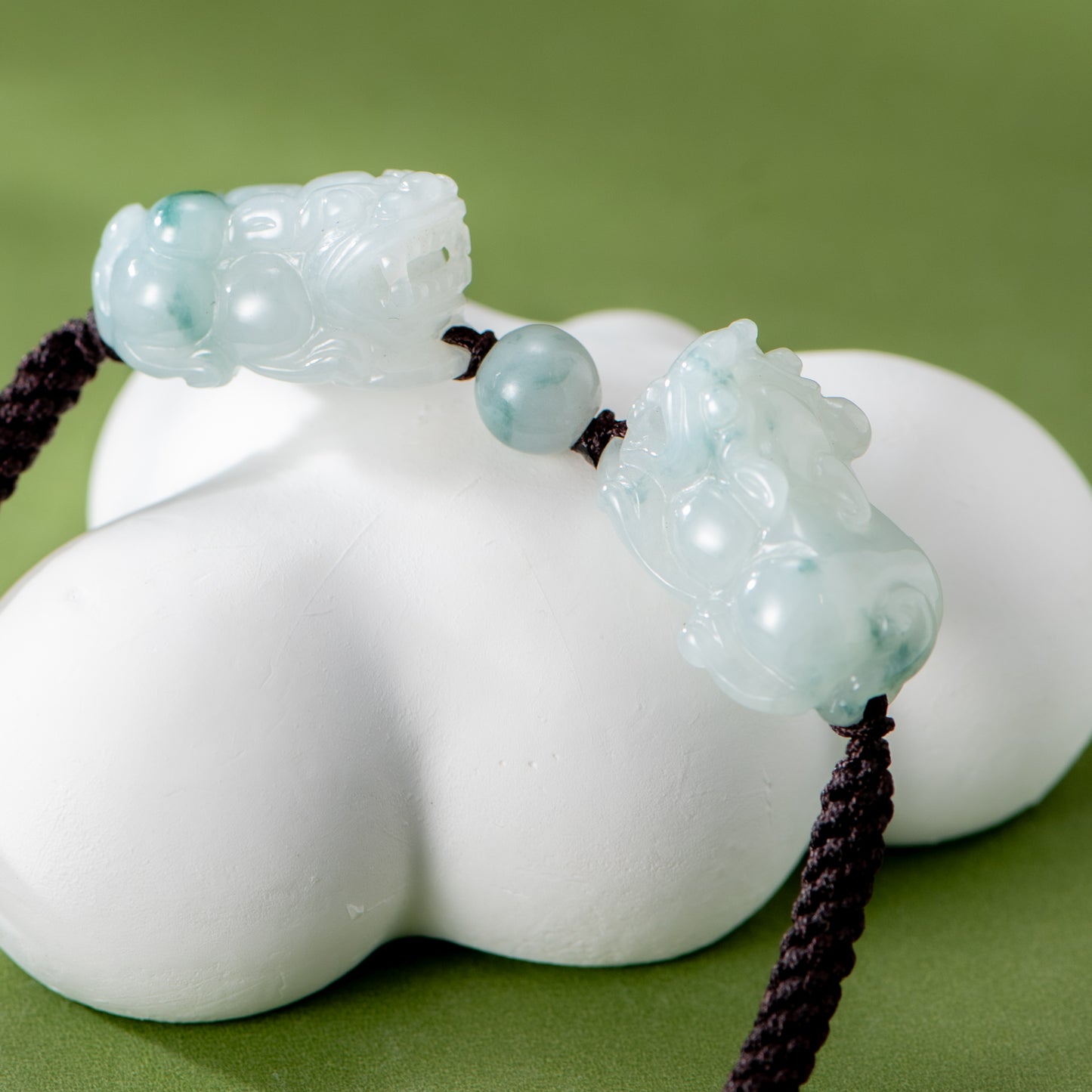 Decorative item with jade-like beads on a green background
