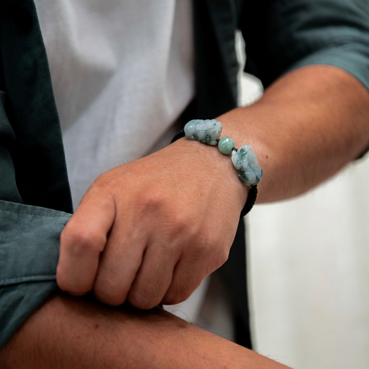 Person wearing a bracelet with blue beads on a blurred background