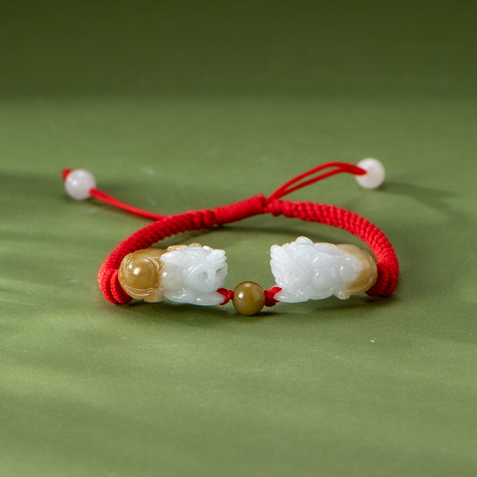Red string bracelet with white and brown beads on a green background