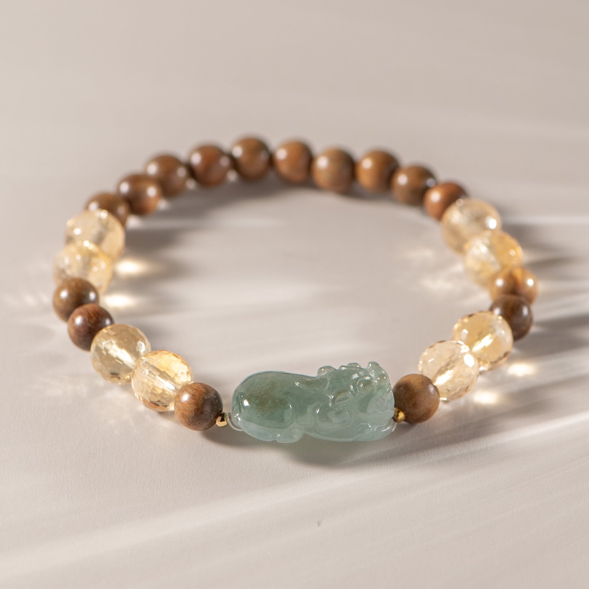 Beaded bracelet with wooden and stone beads on a light background