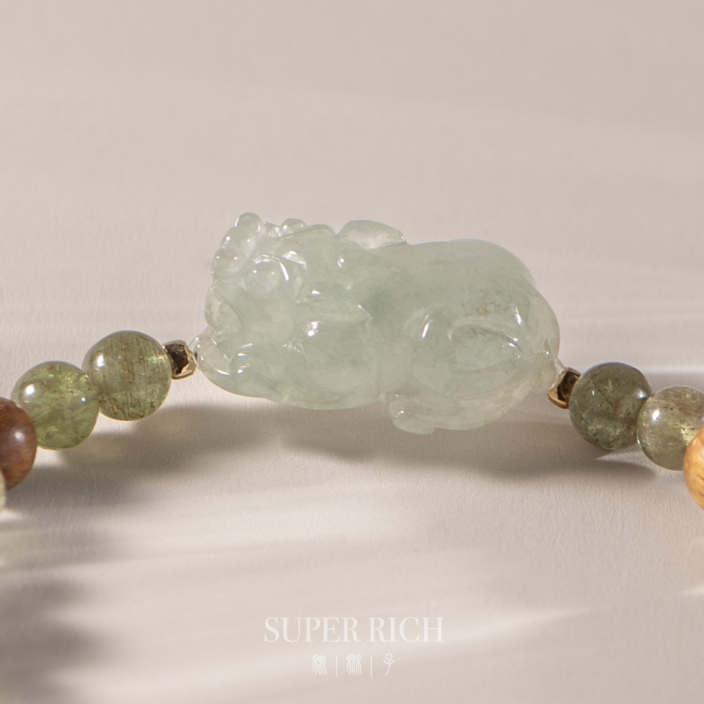 Necklace with jade tiger pendant and multicolored beads on a neutral background