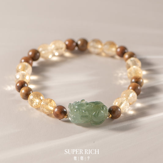 Beaded bracelet with a green carved stone on a light background, featuring the brand 'SUPER RICH'.