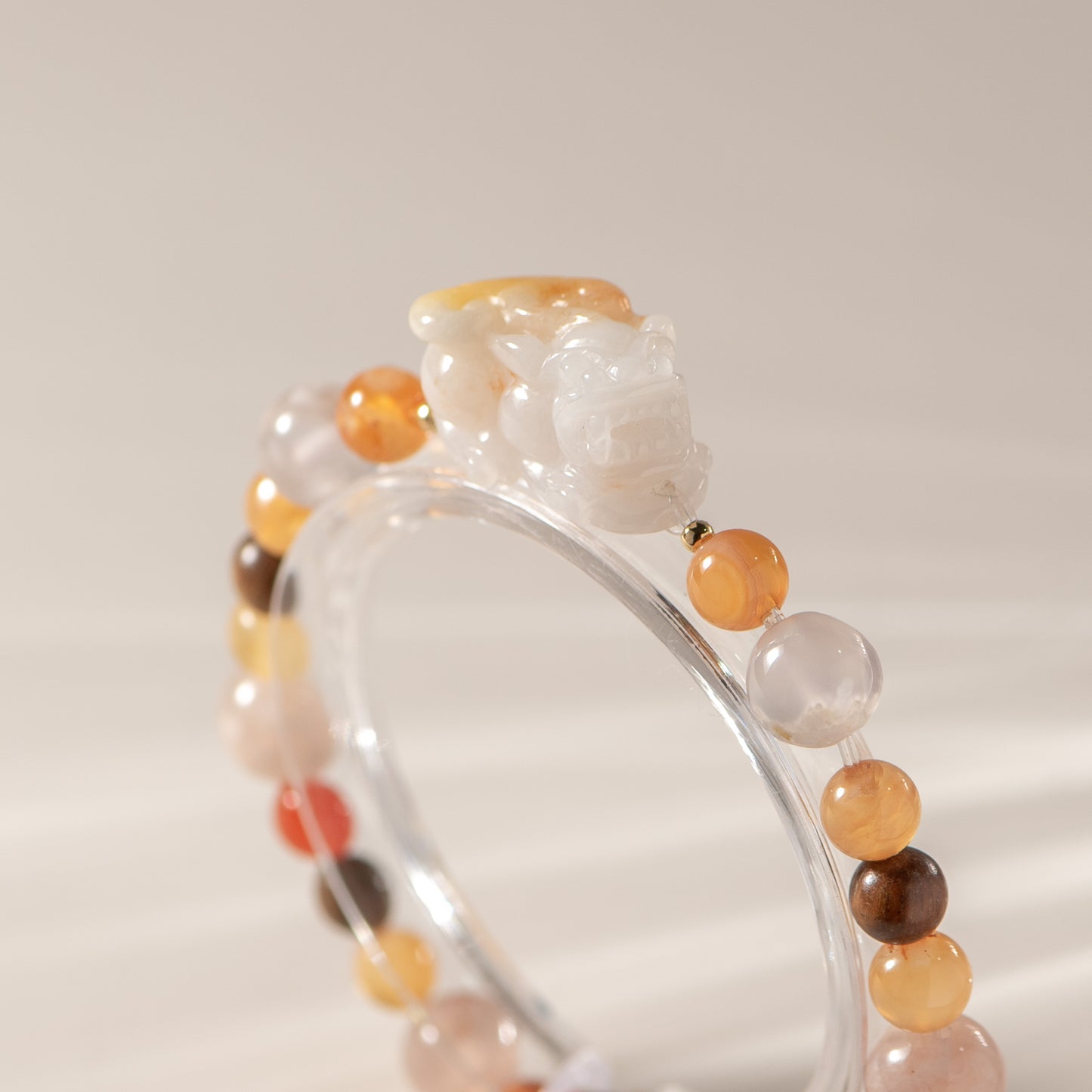 Beaded bracelet with multicolored beads on a neutral background