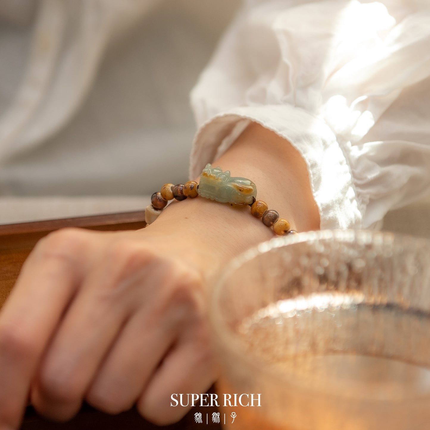 Close-up of a wrist wearing a beaded bracelet with a blurred background