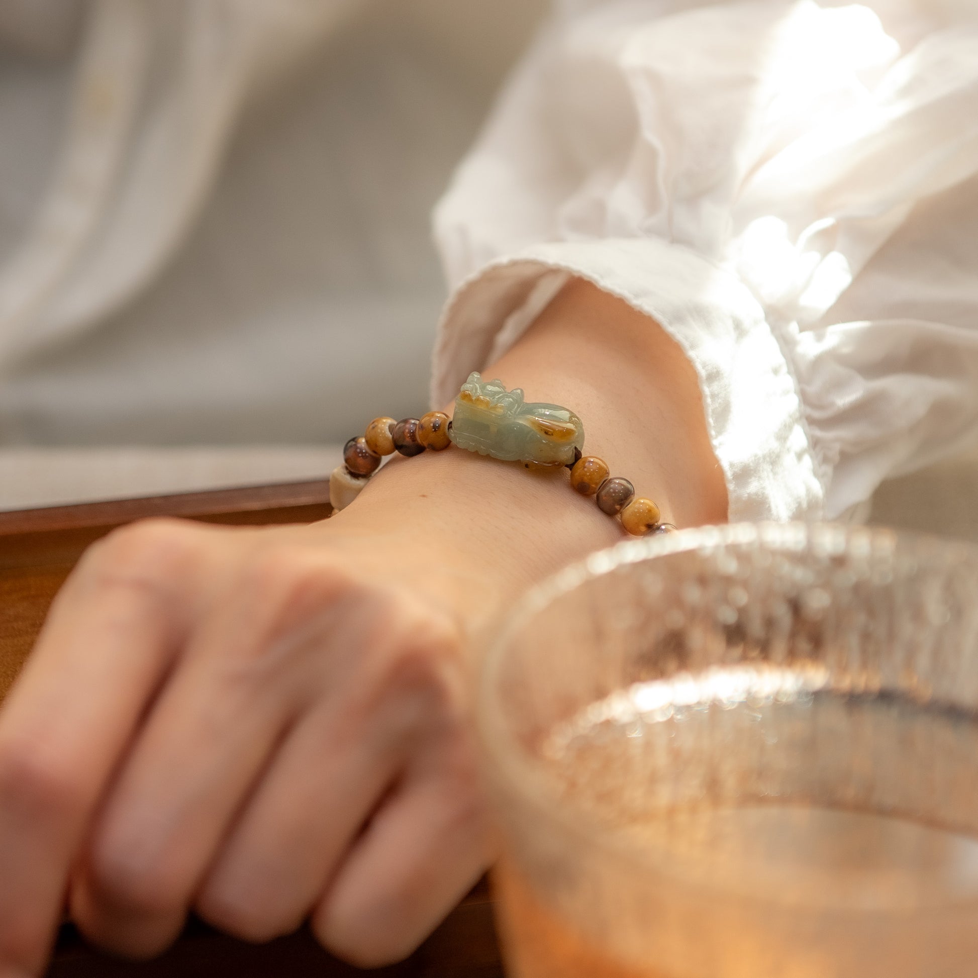 Close-up of a wrist wearing a bracelet with a blurred background