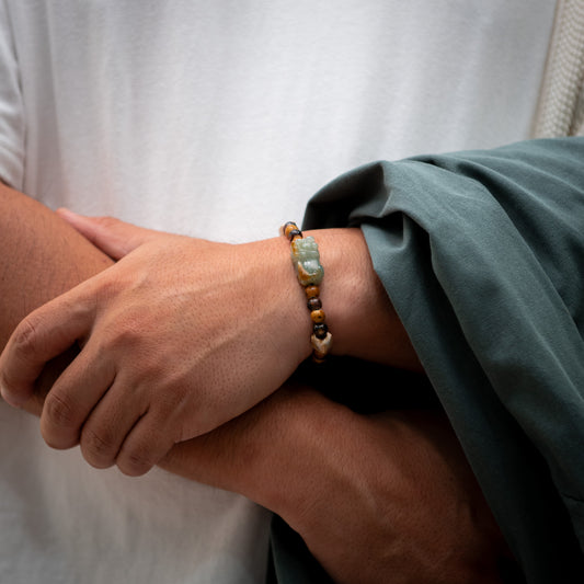 Close-up of a wrist wearing a bracelet with a neutral background