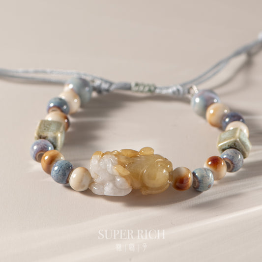 Necklace with multicolored beads and a large central stone on a neutral background