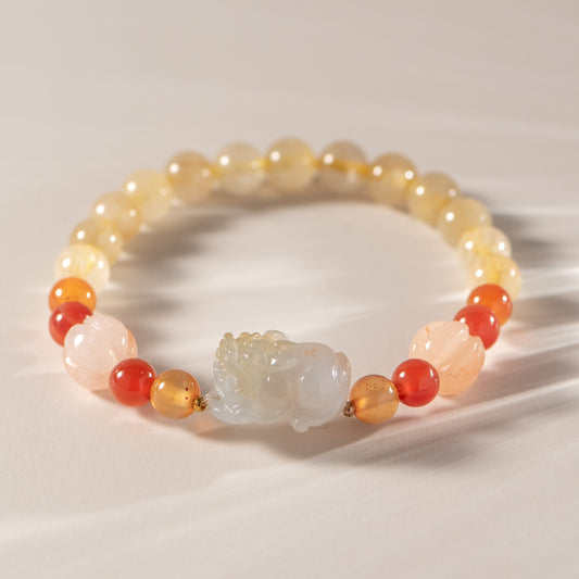 Beaded bracelet with a central stone on a neutral background