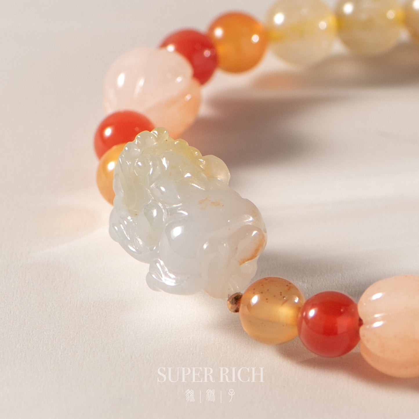 Bracelet with a jade pendant and multicolored beads on a light background