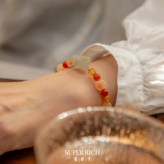Close-up of a foot wearing a colorful beaded bracelet with a blurred background.