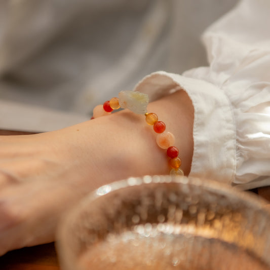Close-up of a foot wearing a colorful beaded anklet with a blurred background