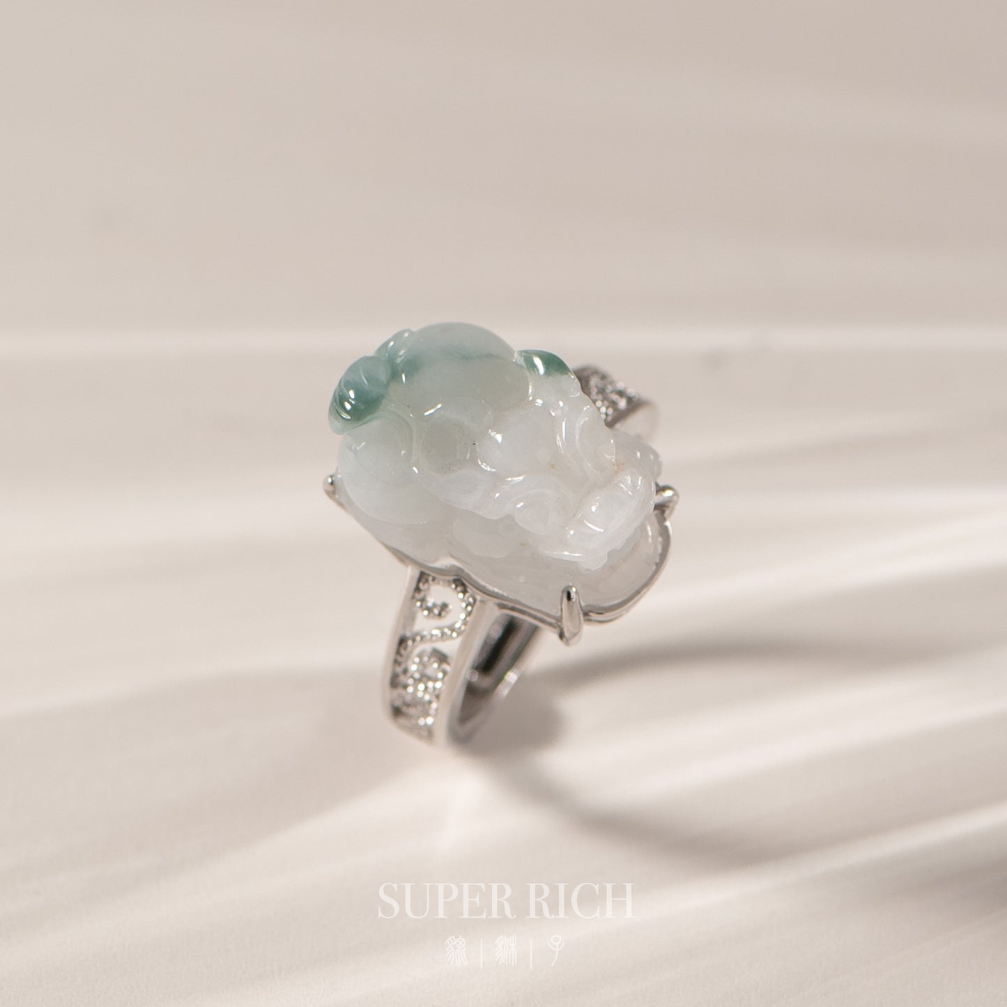 Jade ring with silver accents on a light background