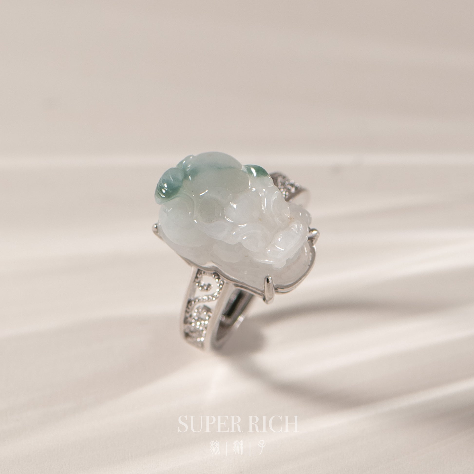 Jade ring with silver accents on a light background